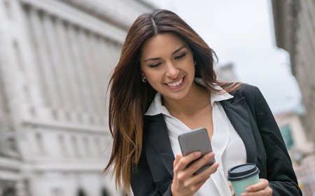 Happy woman using mobile phone