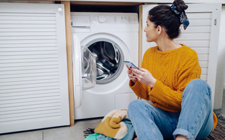women checking washing machine