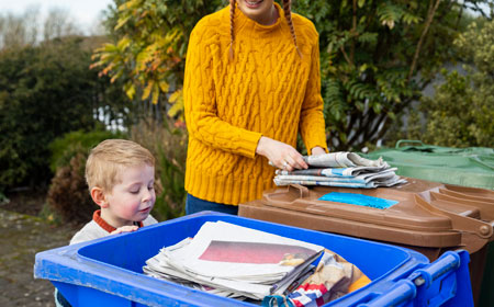 mother and son recycling paper